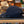Navy blue cap on a grill with a blurred store interior in the background