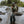 Man fishing in a river surrounded by trees and rocks