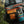 Fishing bag with visible brand logo and fishing equipment on a blurred natural background