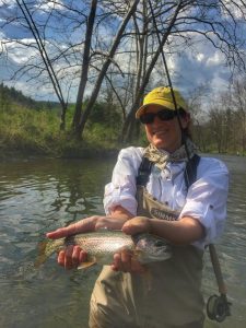 happy angler with a nice rainbow trout.