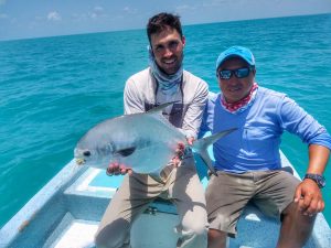 Very happy angler and guide with a Belize and Central America permit caught at La Pescadora Lodge, Ascension Bay, Mexico.