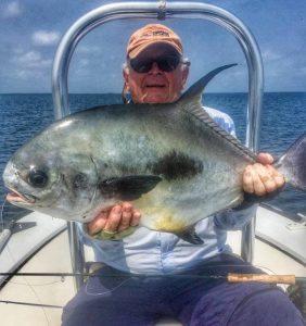 Very happy angler with his 10th lifetime permit caught at Turneffe Flats, Belize.