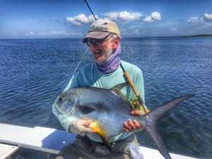 Angler holding a Belize and Central America permit caught at Turneffe Flats, Belize.