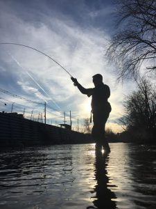 This angler in fighting a trout at sunset during a guide trip in Virginia.