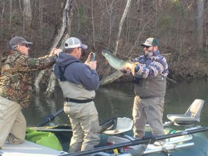Anglers taking a picture of a musky caught on the James River.Photo posted in photo gallery.