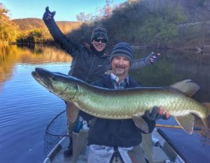 Guide and angler with a large musky on the James river.