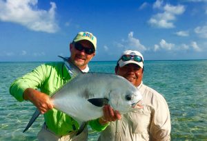 Angler and guide with a permit caught while fishing Ascension Bay Mexico at Casa Blanca lodge.