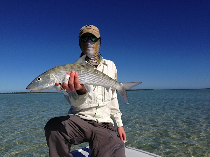 Angler holding bonefish caught while fishing with Swains Cay Lodge on Andros Island Bahamas.