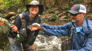 Angler and guide with brook trout on the Rapidan river virginia.