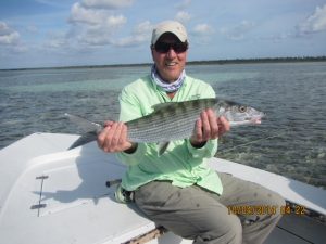 Angler with bonefish on Andros Island Bahamas.