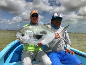 Very happy angler with a beautiful permit caught in Ascension Bay Mexico.