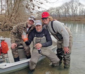 Virginia musky guides/fishing guides celebrating with their angler after landing a very nice musky on the Shenandoah River, Virginia.