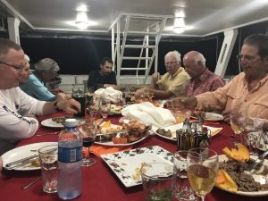 A group of anglers on Avalon 1 mother ship having dinner in Cuba. Fly fish Cuba.