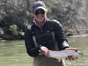 Female angler with a large rainbow trout caught with a Virginia fishing guide.