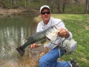 An angler holding a largemouth bass caught in the pond down stream of Graves Mountain Lodge in Syria Virginia.